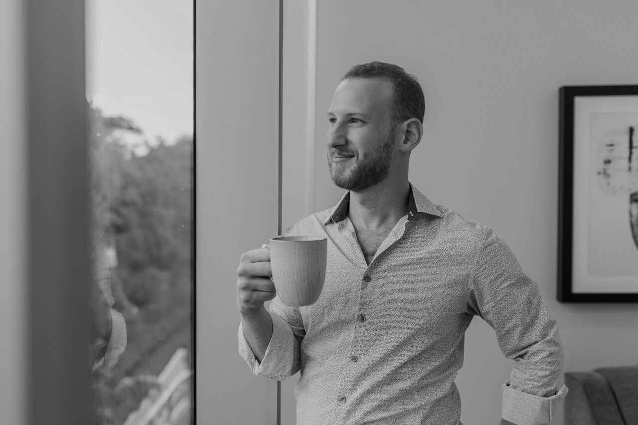 Shaya Schtroks with coffee by window